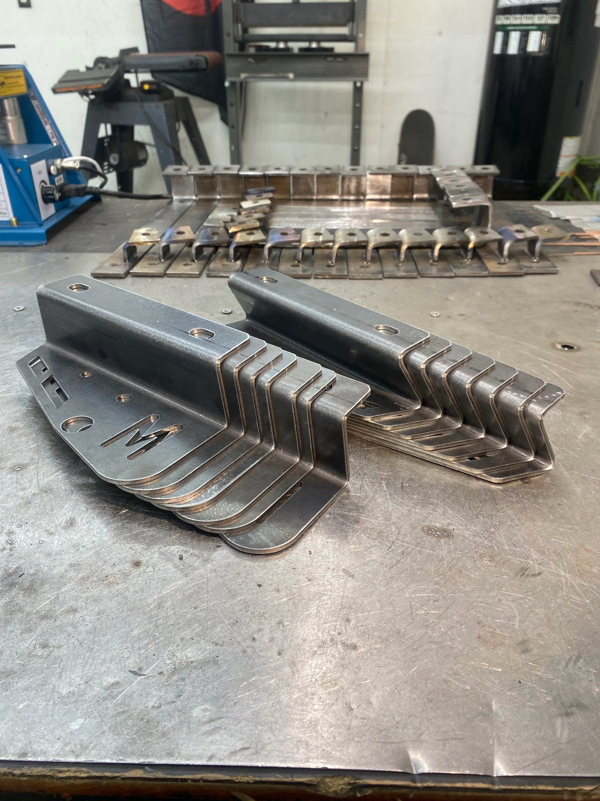 Stack of bent sheet metal brackets